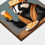 A gallery wrapped canvas of a badger wearing a cheesehead hat holding a glass of beer leaning up against a wall