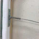 a close up of a ready to hang wire of the back of a gallery wrapped canvas