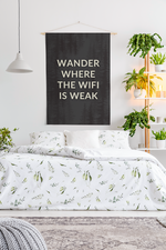 a bedroom with a bed and a plant on the wall