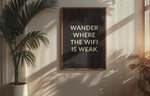 a poster hanging on a wall next to a potted plant