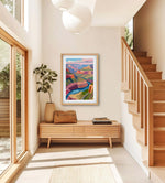 a living room with a couch and a painting on the wall