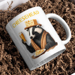 a coffee mug with a picture of a badger holding a glass of beer