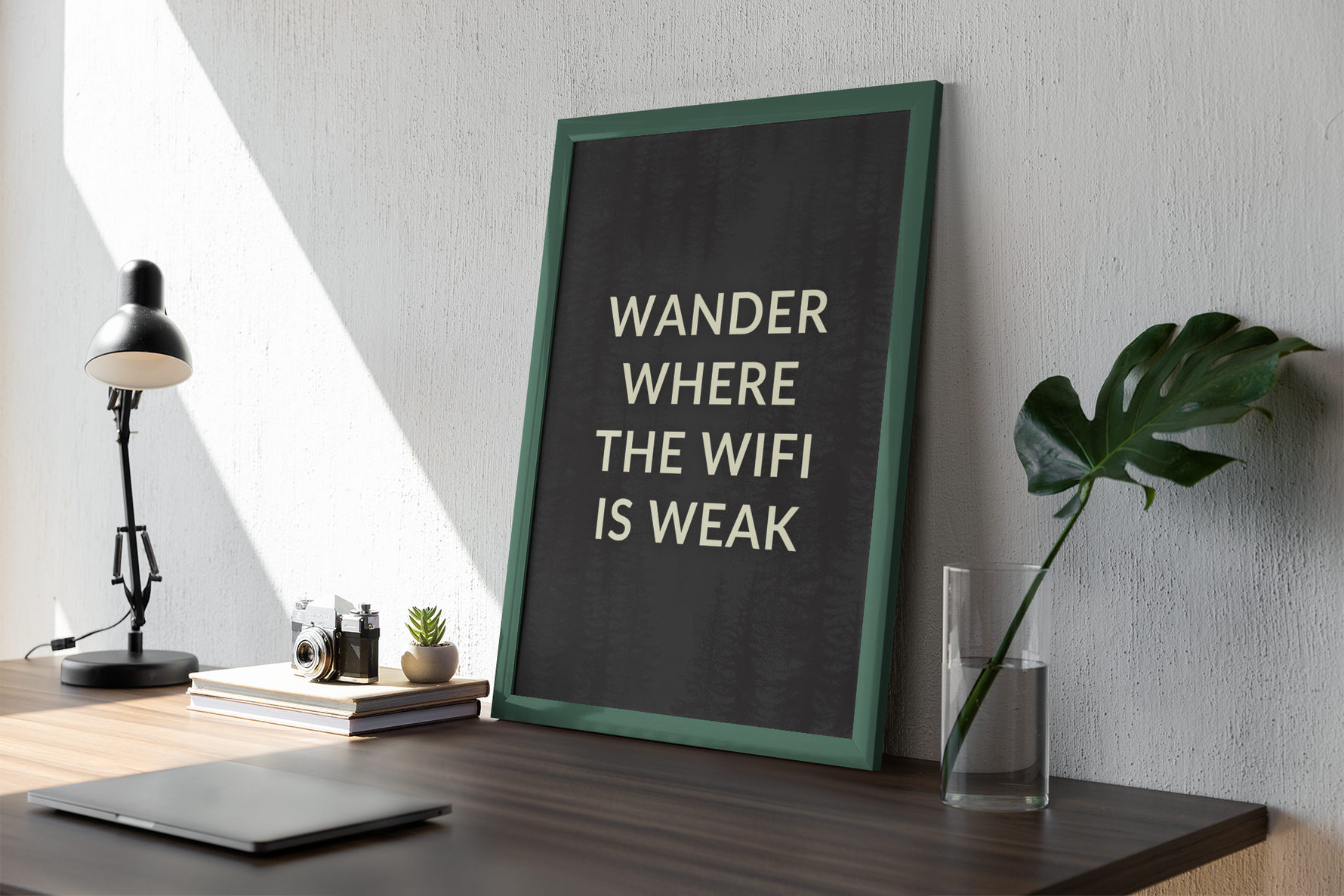 a picture of a desk with a laptop and a plant