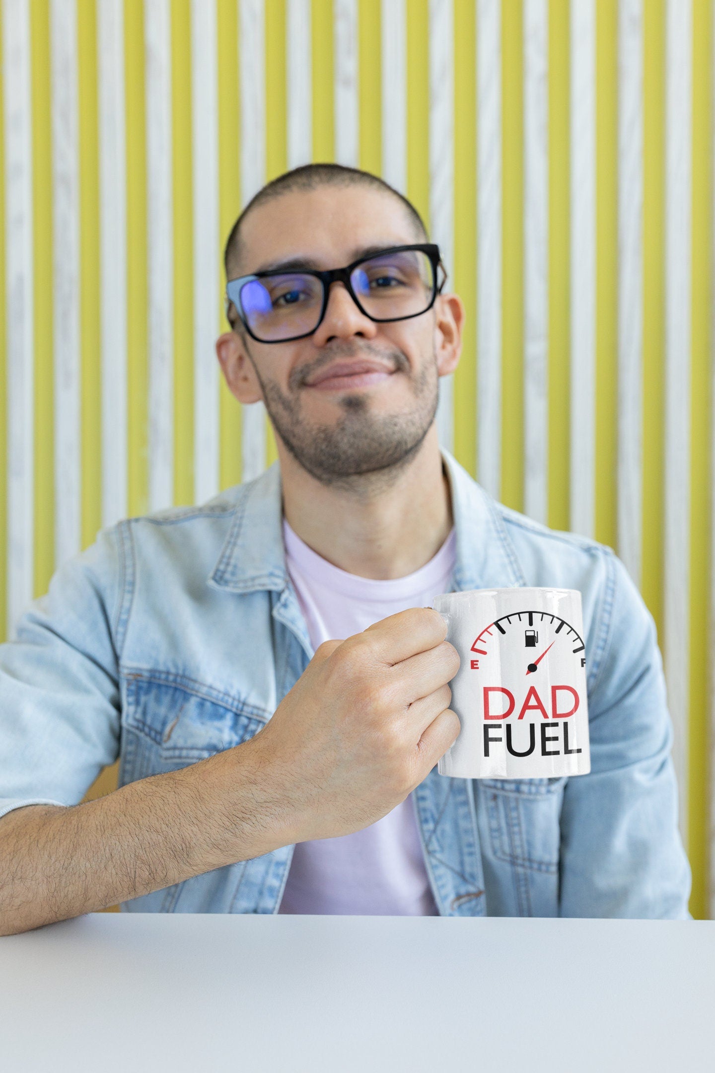 a man holding a coffee mug with the words dad fuel on it
