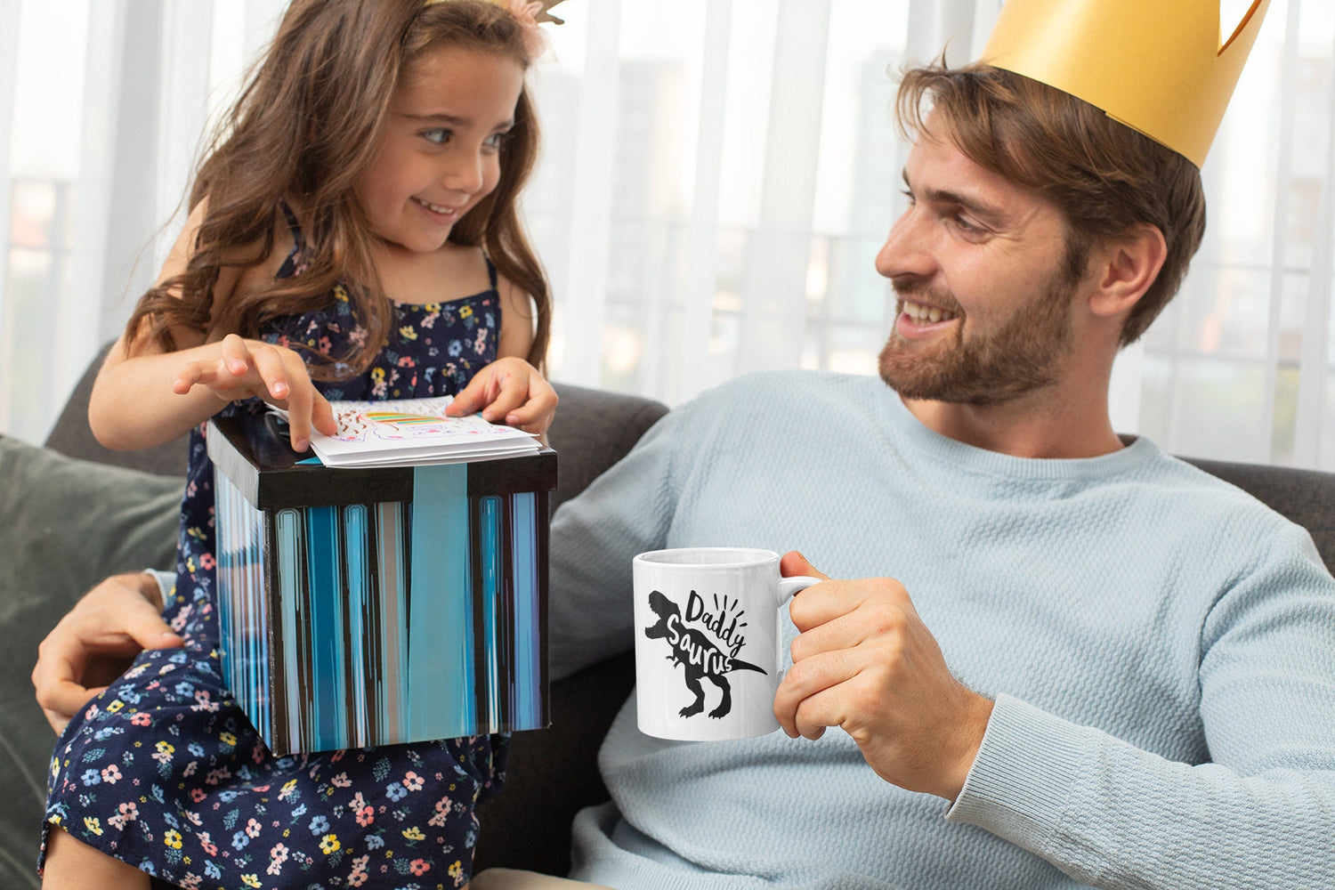 a man and a little girl sitting on a couch