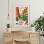 a painting hanging on a wall next to a chair