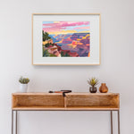 a painting hanging on a wall above a wooden table