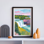 a painting of a waterfall in a frame on a shelf