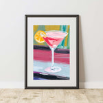 a painting of a blood orange martini with a slice of lemon