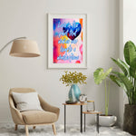 Fine Art Giclee Print - Love is the paint that makes our hearts a masterpiece - framed and matted in a white picture frame hanging on a wall in the living room.