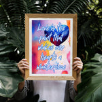 Fine Art Giclee Print - Love is the paint that makes our hearts a masterpiece - framed and matted in a oak picture frame being held up by a person between plants.