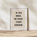 a black and white poster with the words in this house, we speak fluent sarcasm