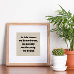 a picture frame sitting on top of a table next to a potted plant